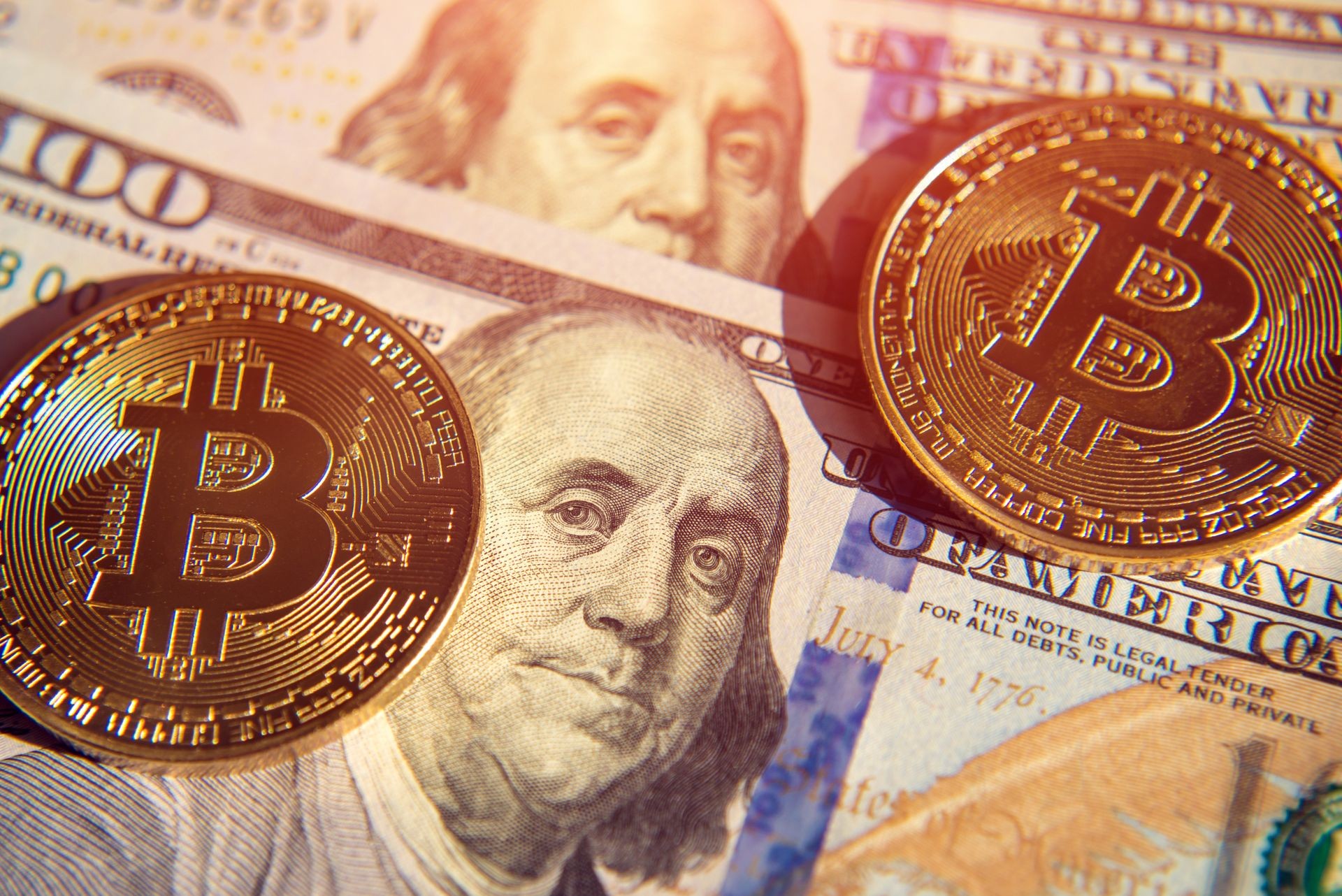 Two bitcoins on dollar bills (Investment, course change - concept) Two bitcoins on dollar bills (Investment, course change - concept)